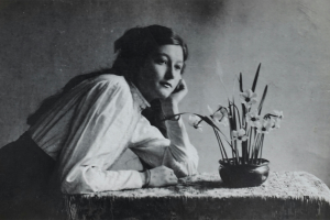 black and white photo of a woman sitting at a desk