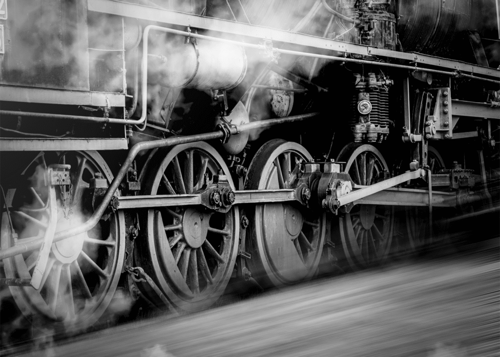 black and white photograph of train wheels on a track